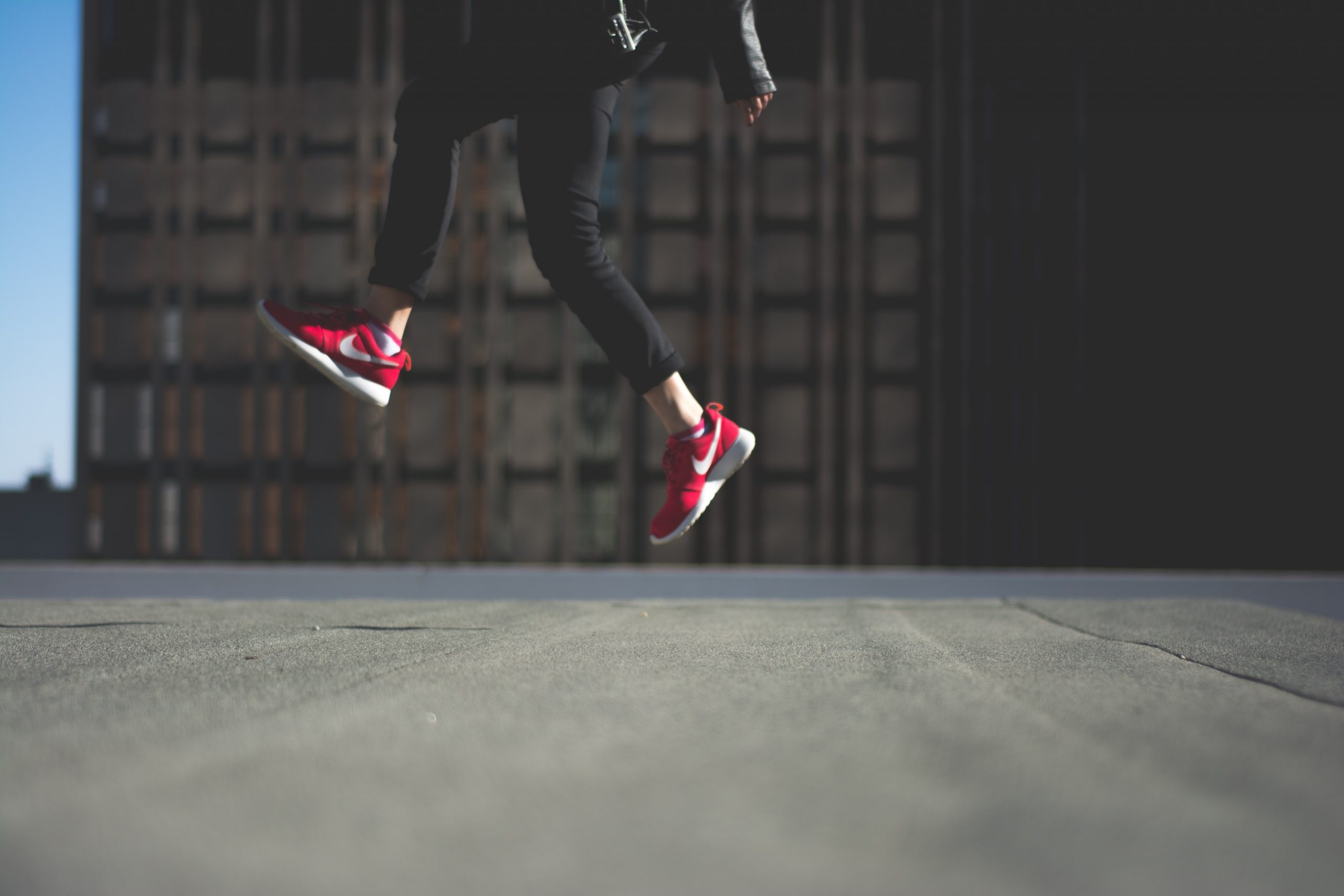 Smart Cities jumping red trainers city
