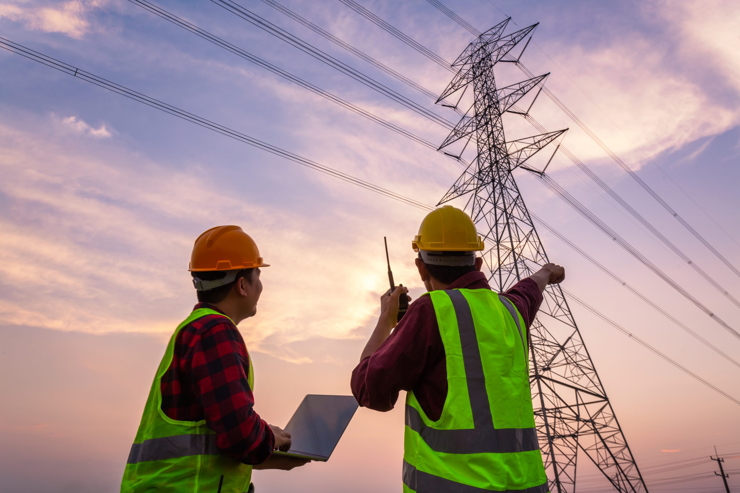 Utility engineers using digital tools to monitor powerlines as part of smart grid solutions
