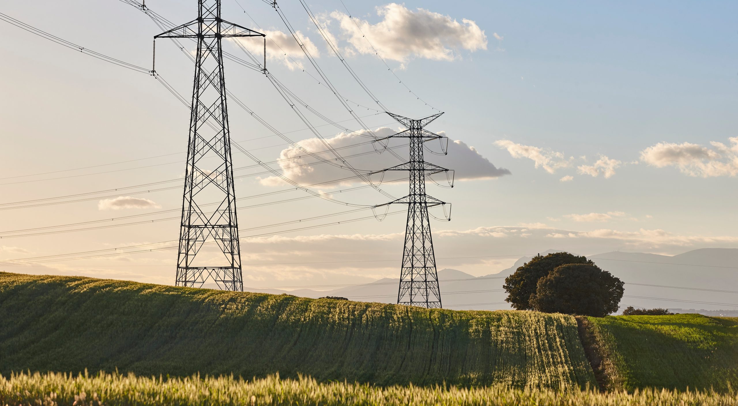 High-voltage transmission towers representing smart grid infrastructure for modern utilities