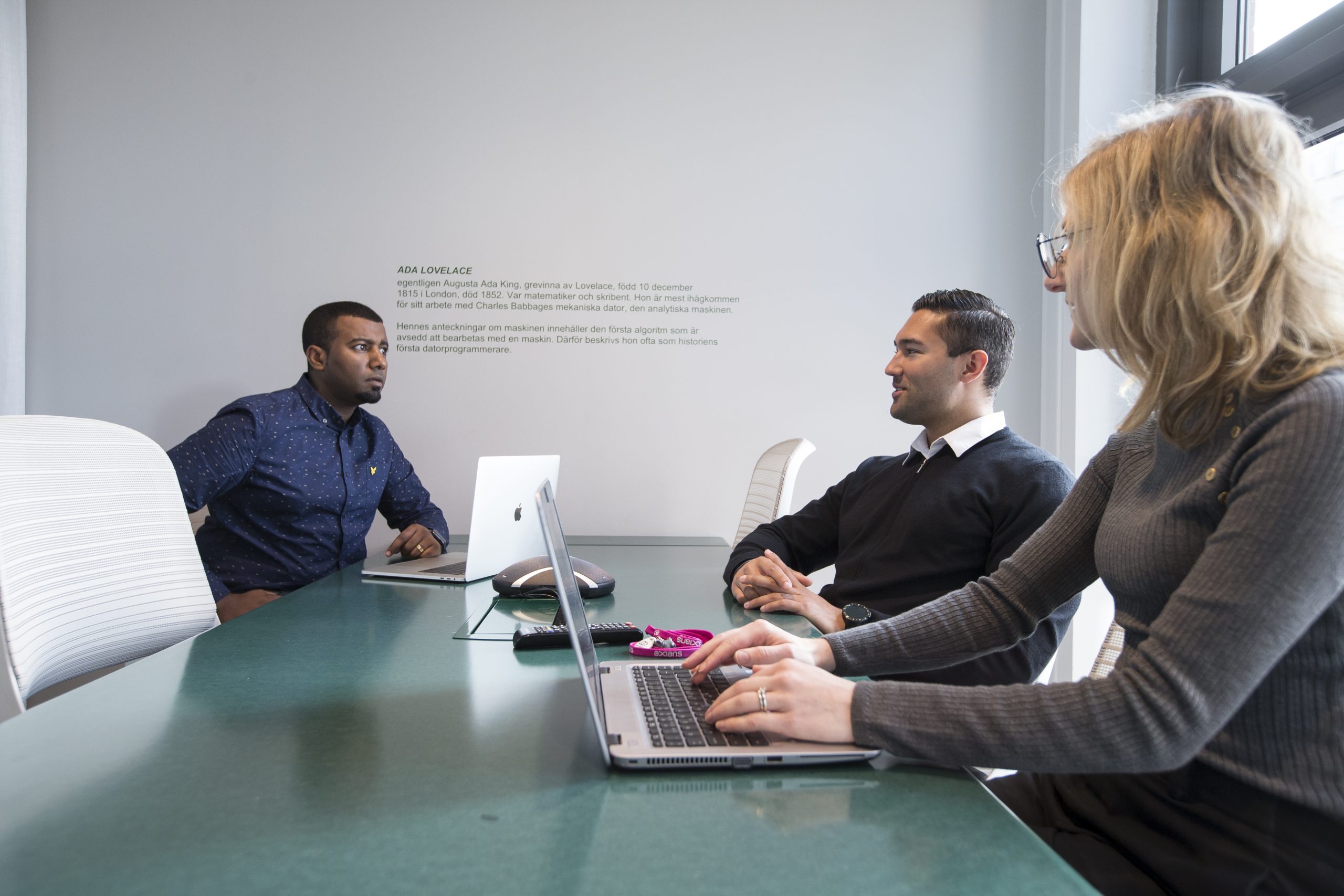 Business professionals collaborating in an office on Microsoft AI Cloud Partner solutions.