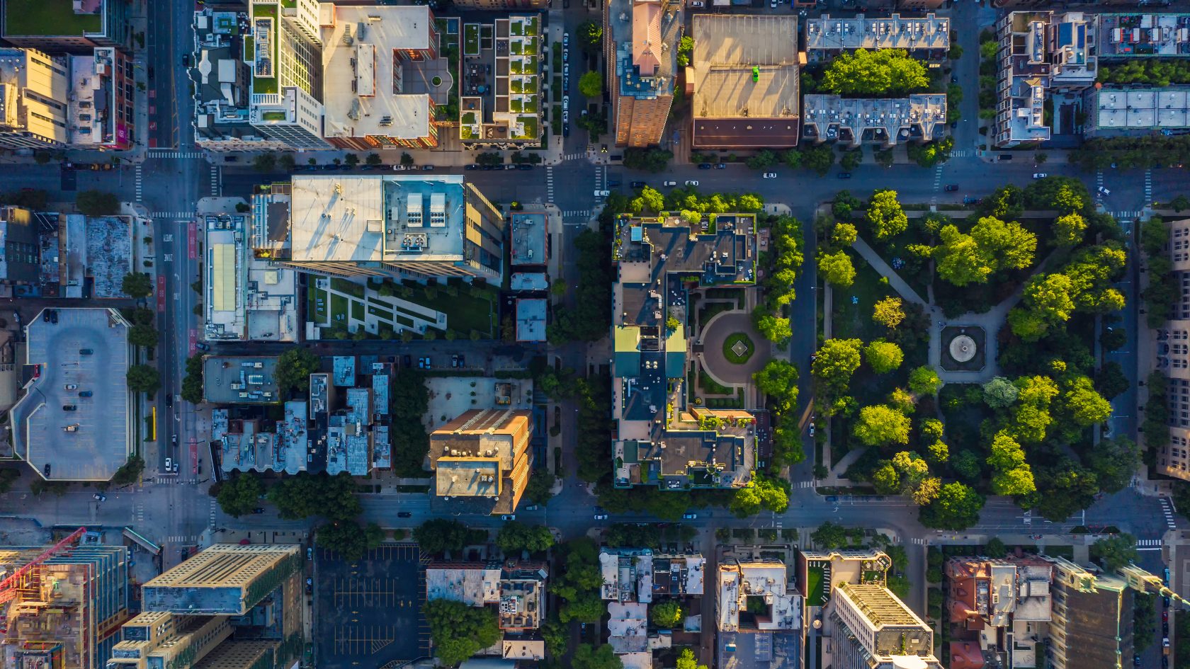 Top-down aerial view of a modern city illustrating urban density, green infrastructure, and the potential for connected, data-driven smart city ecosystem