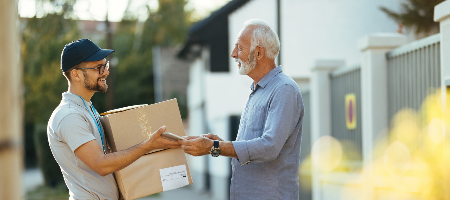 Delivery courier handing a parcel to a customer at the door