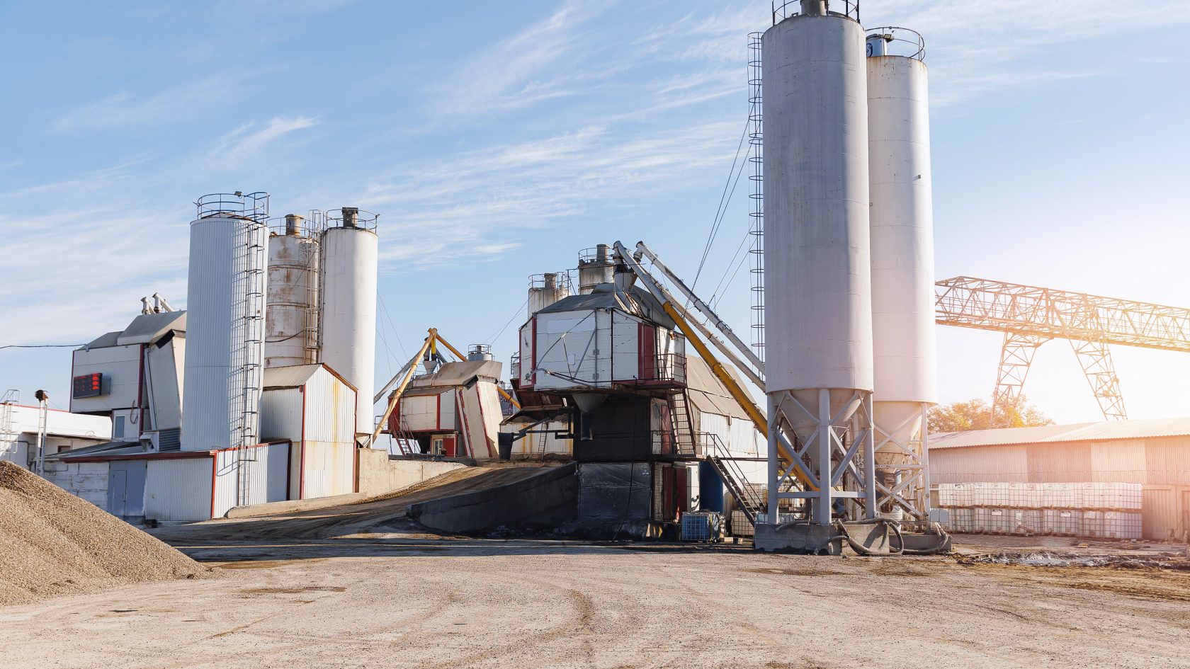 Modern cement plant with silos and trucks supporting digital logistics operations