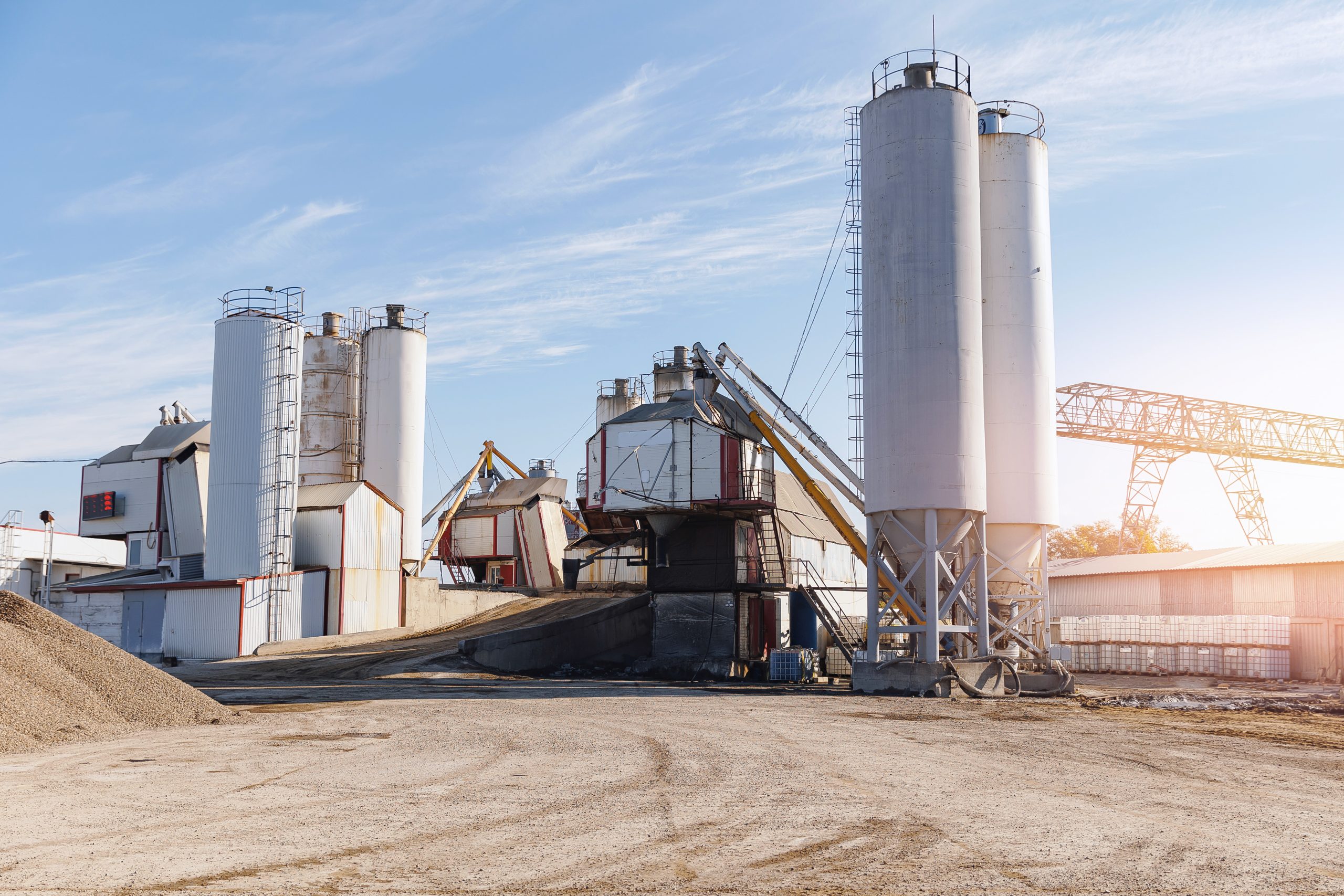 Modern cement plant with silos and trucks supporting digital logistics operations