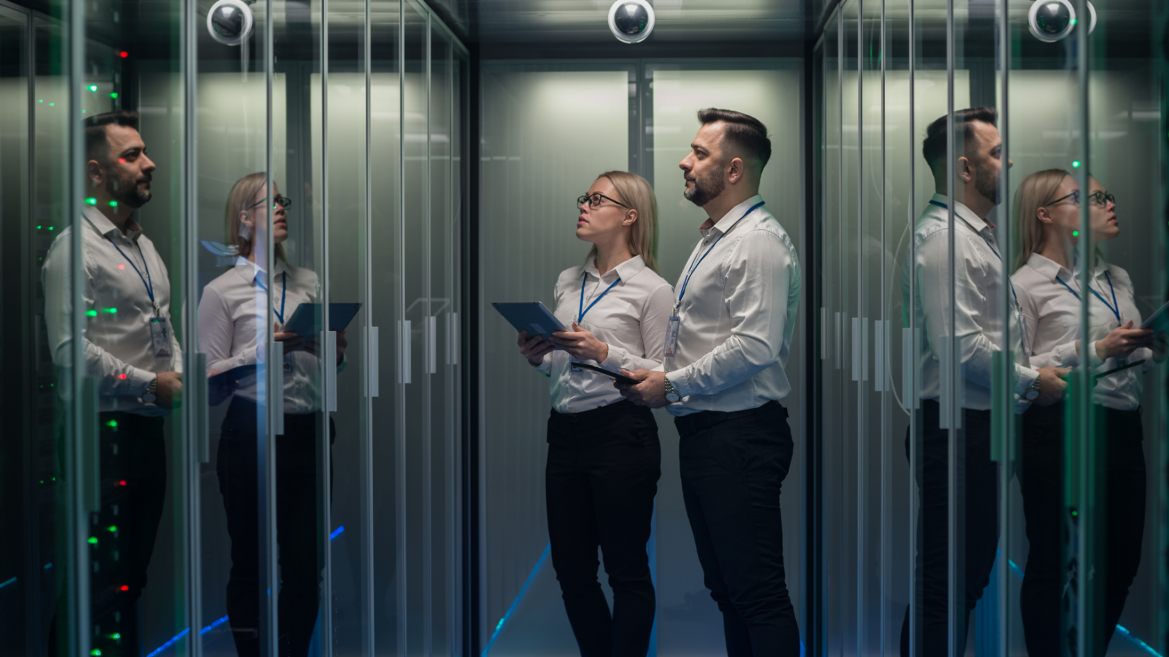 Two IT professionals reviewing cloud infrastructure inside a modern data centre.