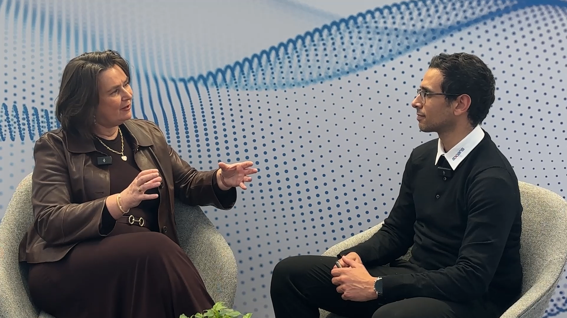 José Van Dijk and an Axians interviewer discussing the Axians–Cisco partnership, AI innovation, and the Cisco 360 Partner Program at Cisco Live Amsterdam