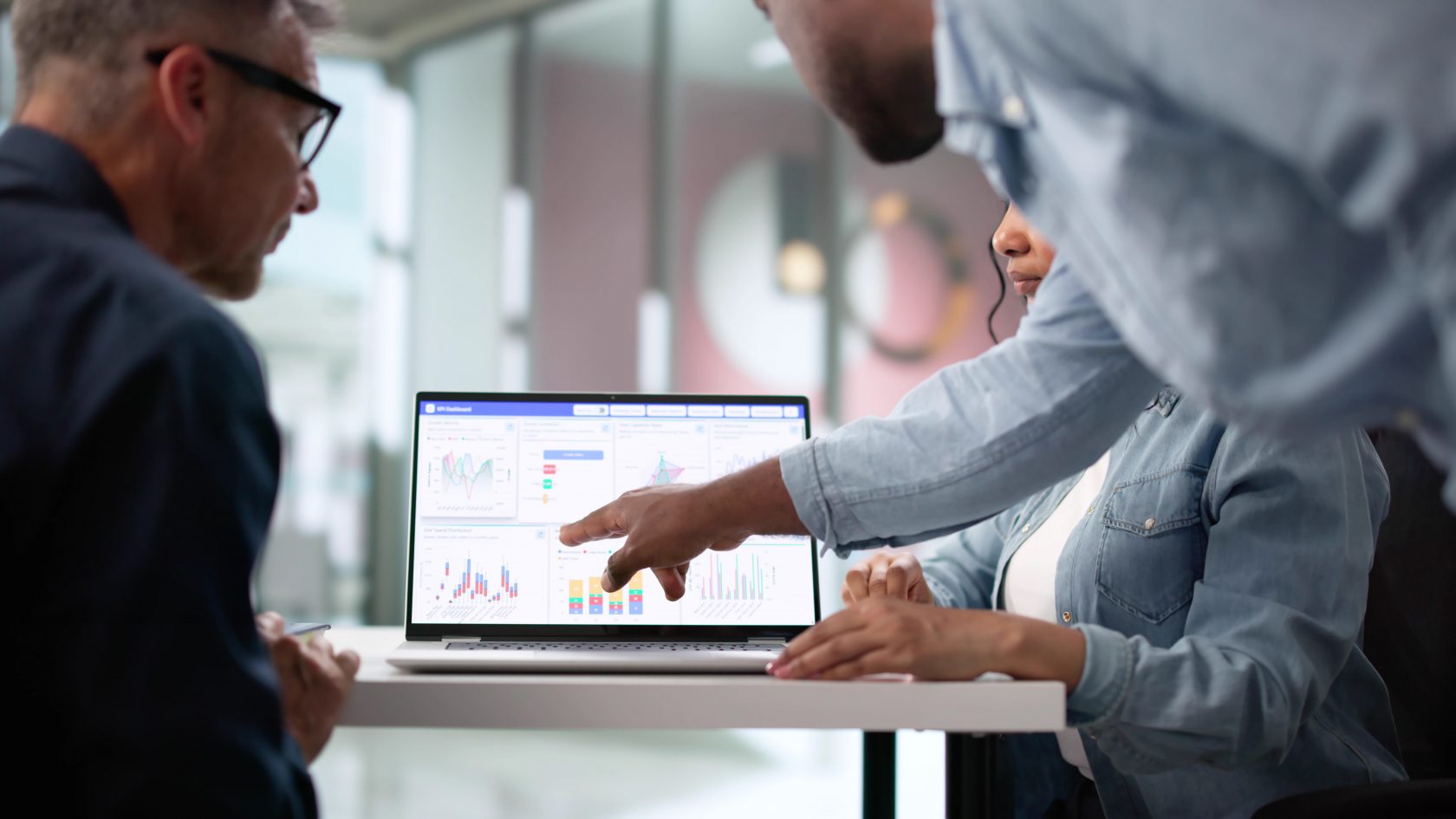 Business professionals reviewing application performance and analytics on a laptop.