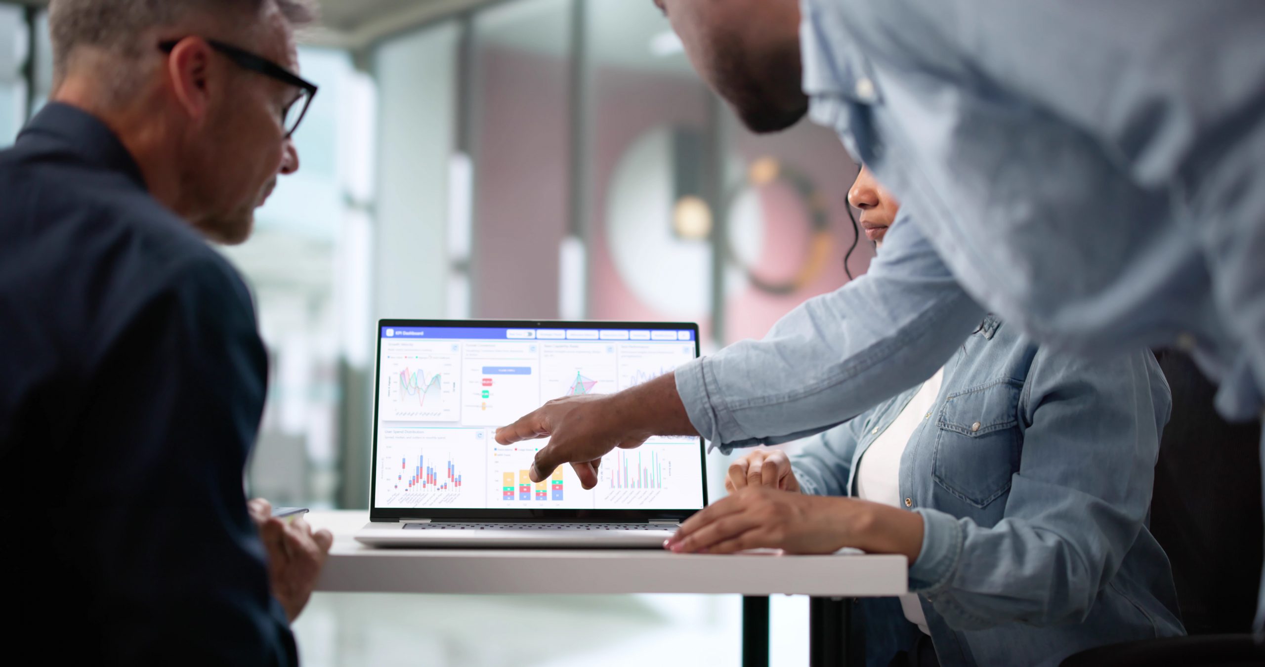 Business professionals reviewing application performance and analytics on a laptop.
