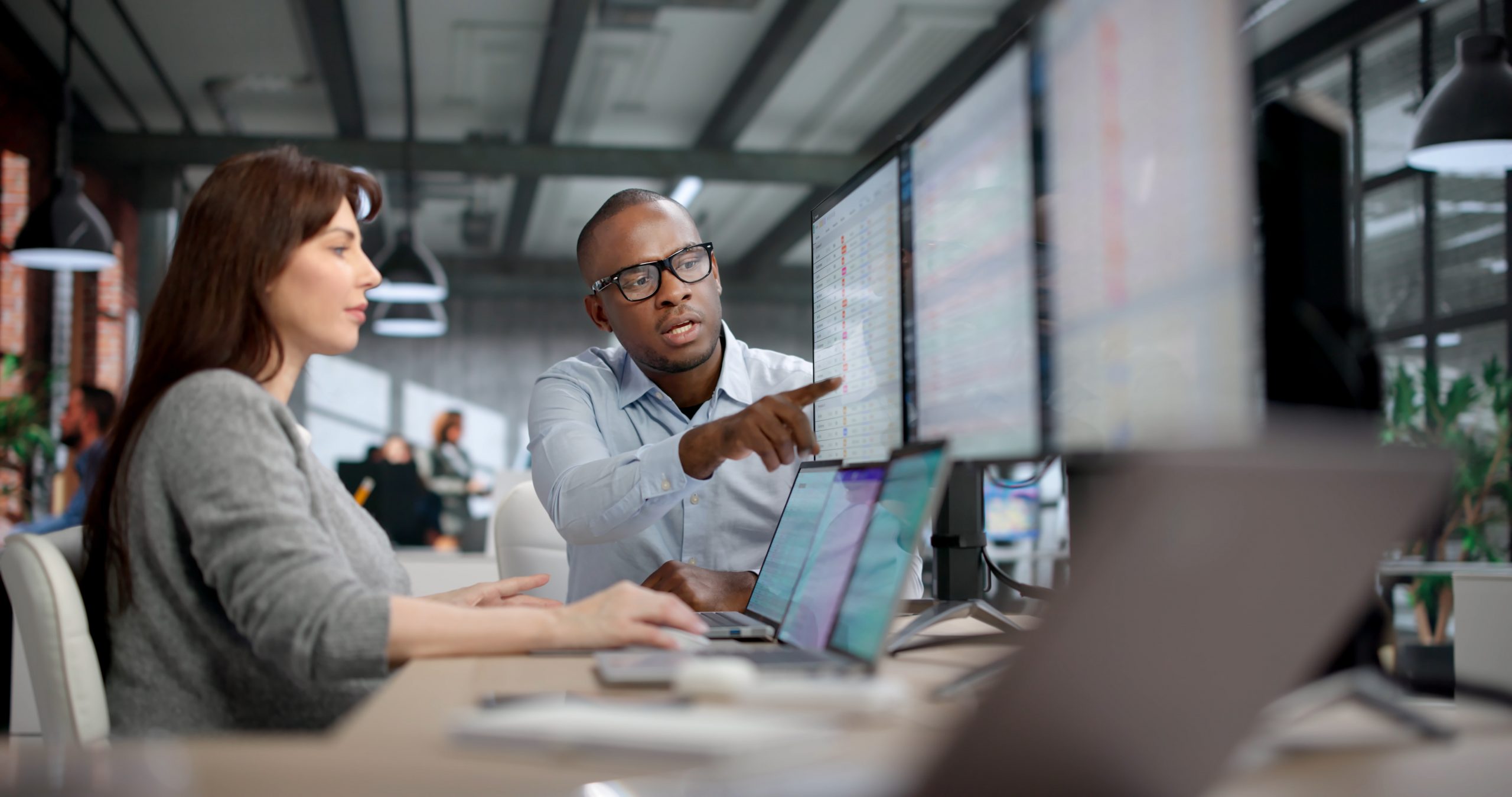 Business professionals reviewing analytics dashboards during a digital transformation project.