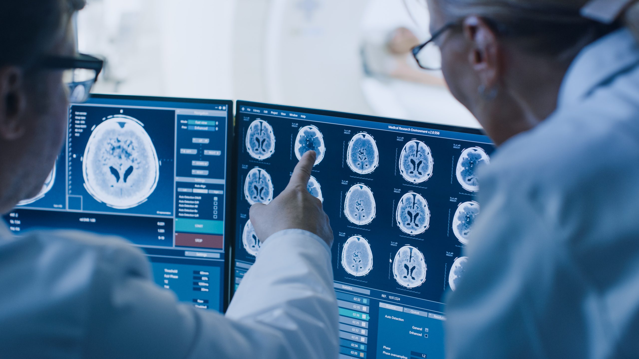 Healthcare professionals analyzing digital medical imaging and AI-assisted diagnostic data.