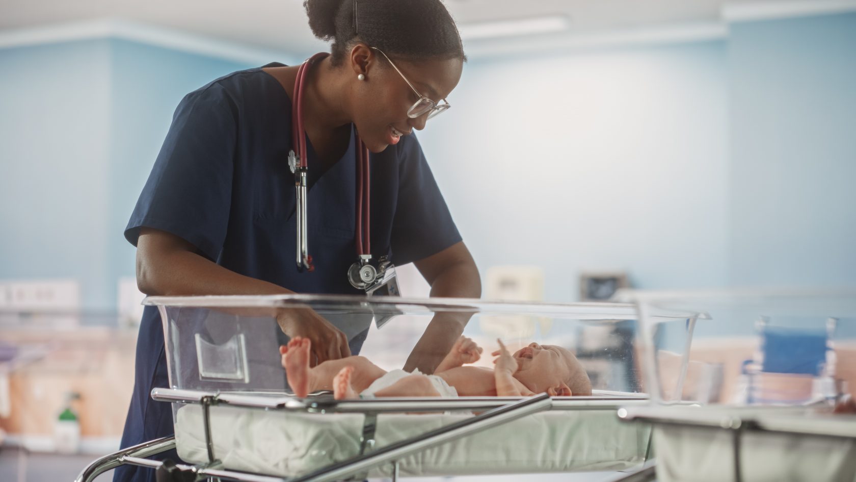 Healthcare professional caring for a newborn in a maternity ward