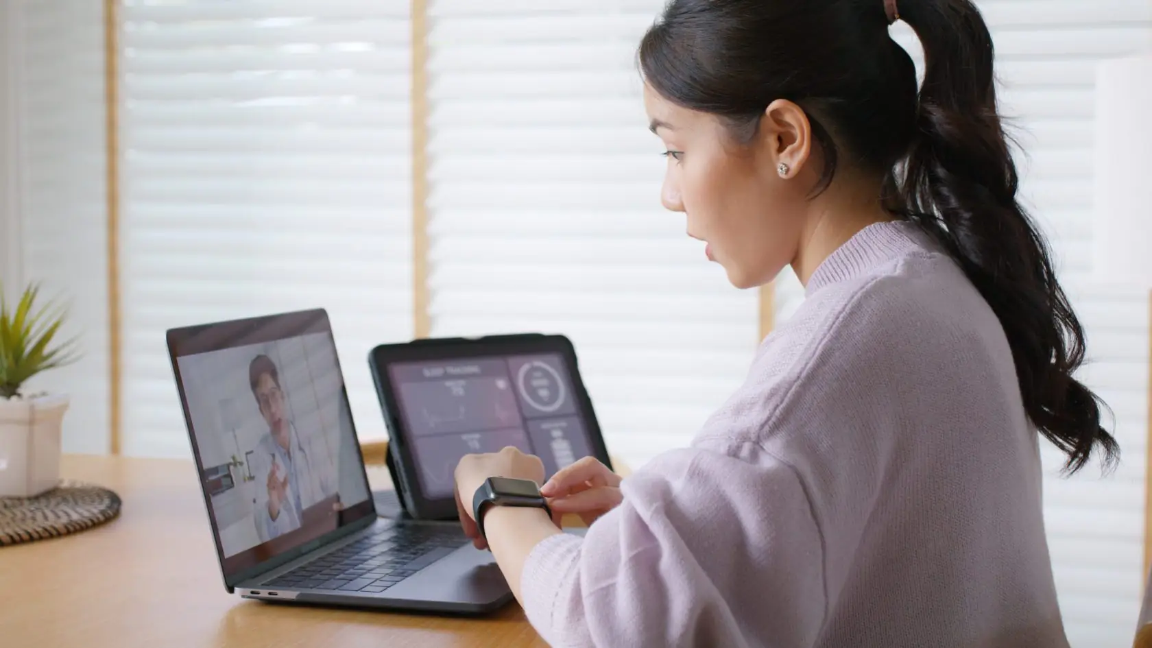 Patient using a wearable health device during a telemedicine consultation with a healthcare professional