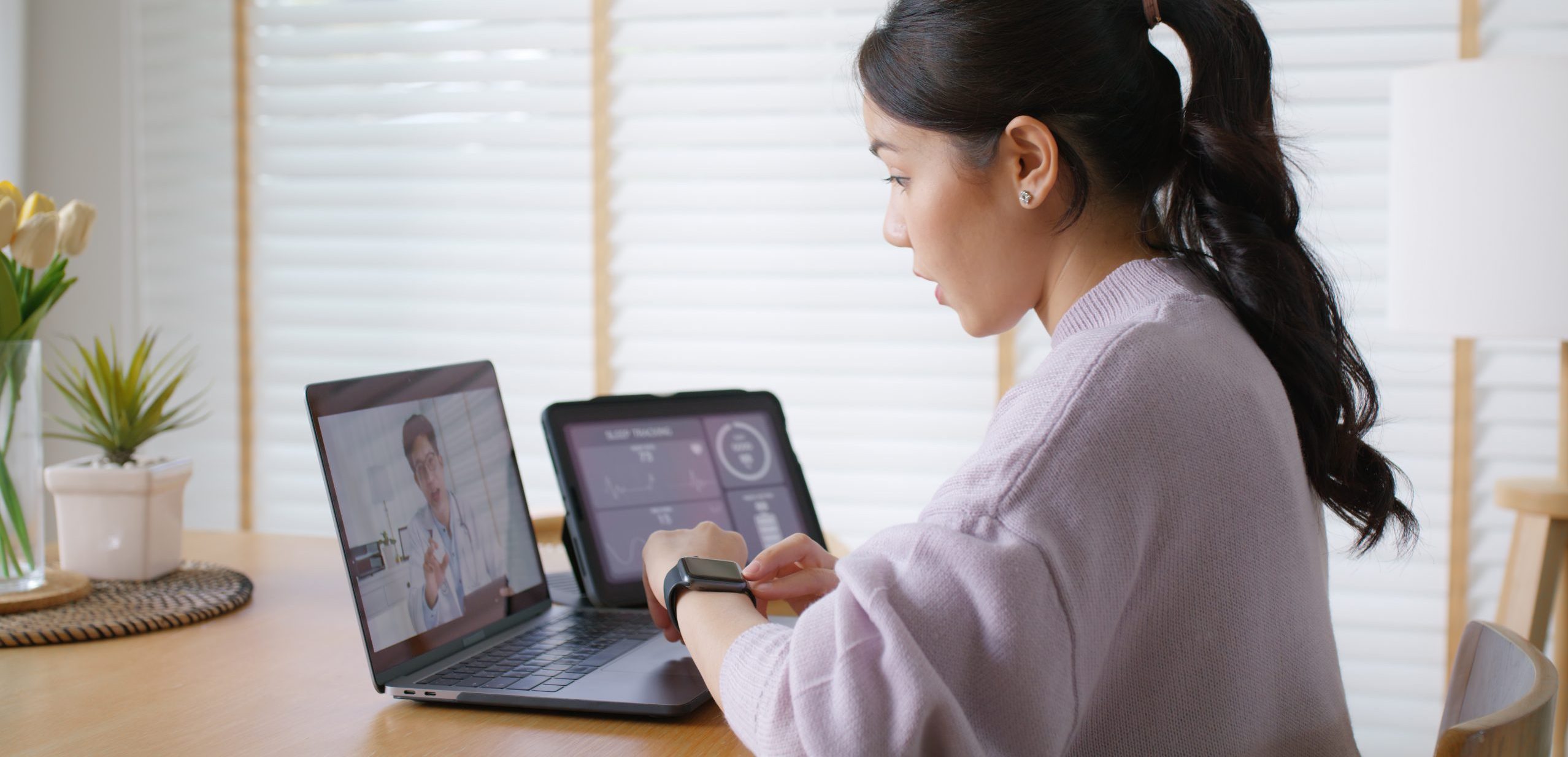 Patient using a wearable health device during a telemedicine consultation with a healthcare professional