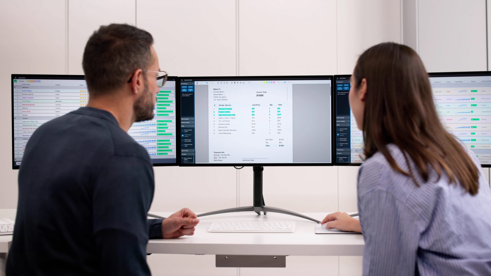 Two professionals reviewing project evaluation data and digital assessment dashboards on multiple screens.