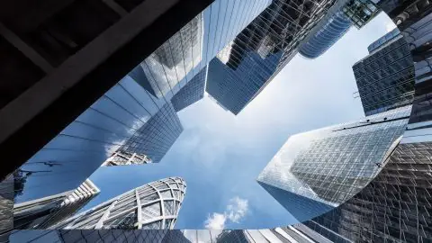 Modern skyscrapers viewed from below, representing the digital transformation and resilient infrastructure supporting the future of banking.