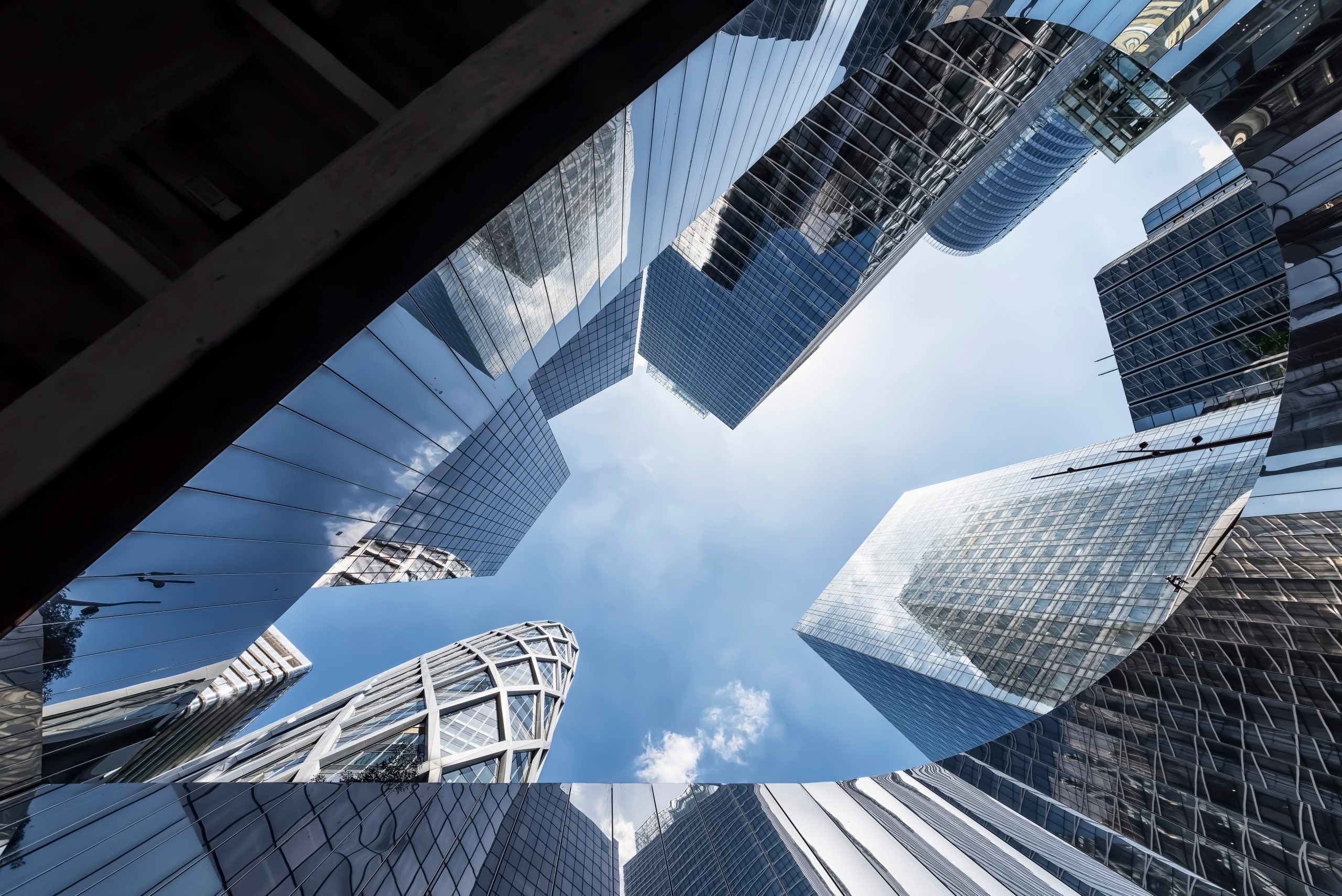 Modern skyscrapers viewed from below, representing the digital transformation and resilient infrastructure supporting the future of banking.