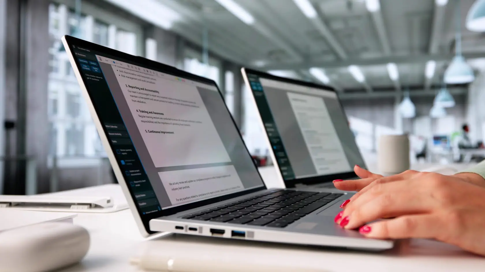 User reviewing AI-generated document summaries on a laptop.