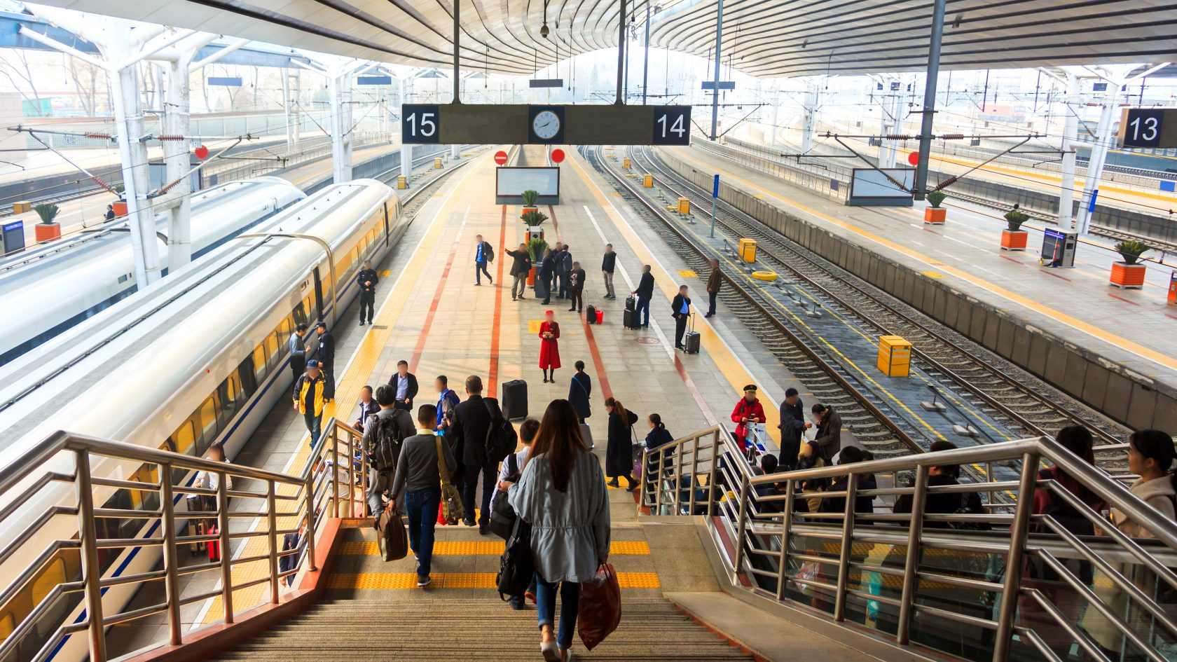 Passengers moving through a busy railway station, representing connected transport infrastructure and integrated mobility systems.