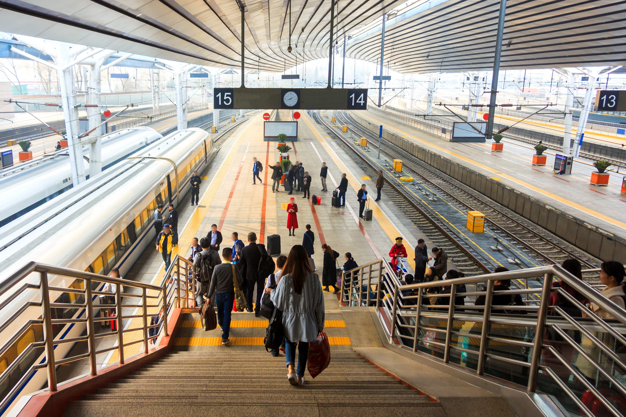 Passengers moving through a busy railway station, representing connected transport infrastructure and integrated mobility systems.